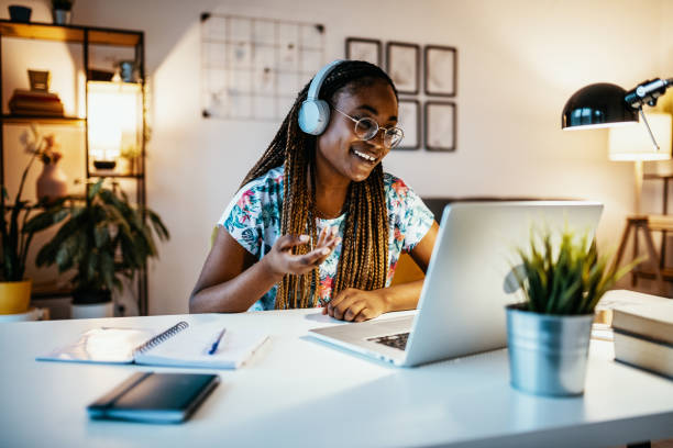A student smiling and talking in a live online class